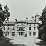 Exterior of imposing Victorian building at Langdon Down with lawn and trees