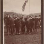 Boys in scout group stand in front of a union jack