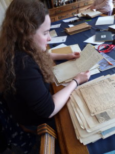 One of our researchers, Anna, is sat at the table looking through a box of letters