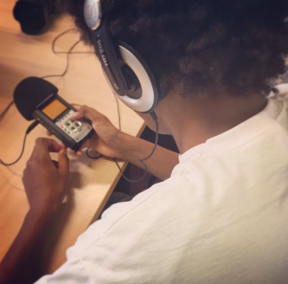 A young person uses a handheld microphone