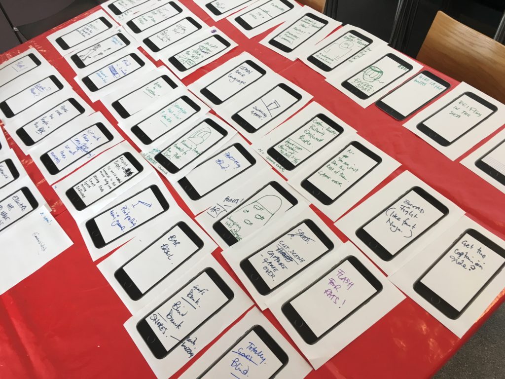 We sketched our ideas for each scene of the game onto pictures of a mobile phone screen-the image shows all f the A5 pieces of paper lined up in order of when the scene occurs in the game
