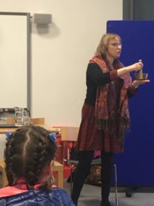 Liz Porter, a partially sighted storyteller who is interested in the representation of disability within traditional stories, stands to tell a story using a musical bowl