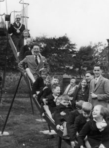 man and several children on a slide