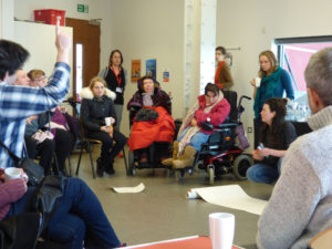 circle of disabled people discuss the mshed exhibition with grace